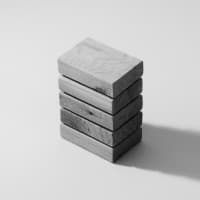 A stack of five rectangular concrete or stone blocks photographed against a light background